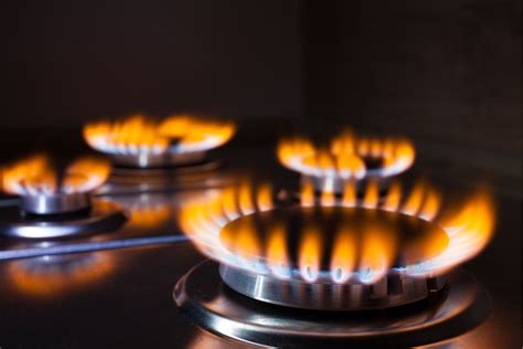 gas stove top has orange flame